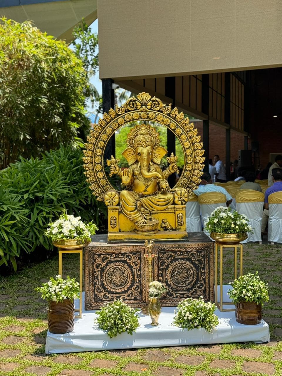 Golden Ganesha idol with floral decoration at a Guruvayur ceremony