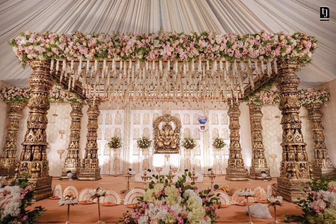 Grand temple-style wedding mandap with pink florals