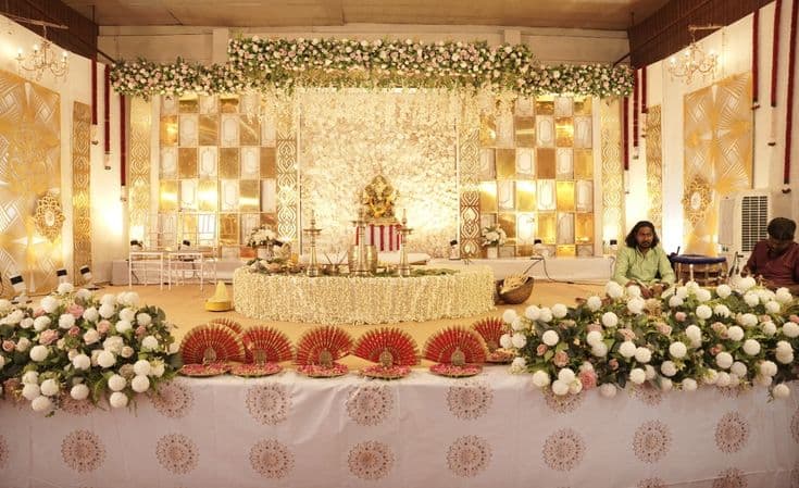 Grand gold and white wedding reception stage in Guruvayur