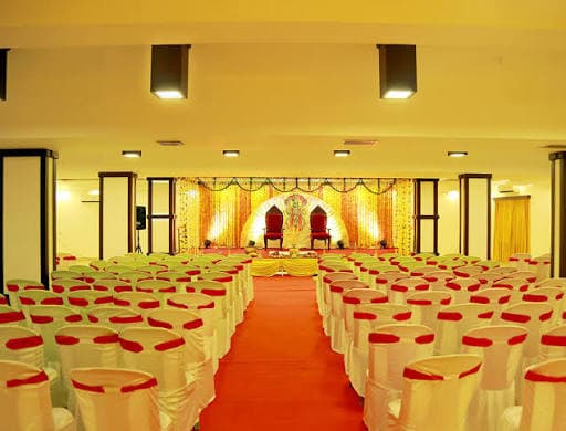 Temple wedding hall with decorated stage and seating
